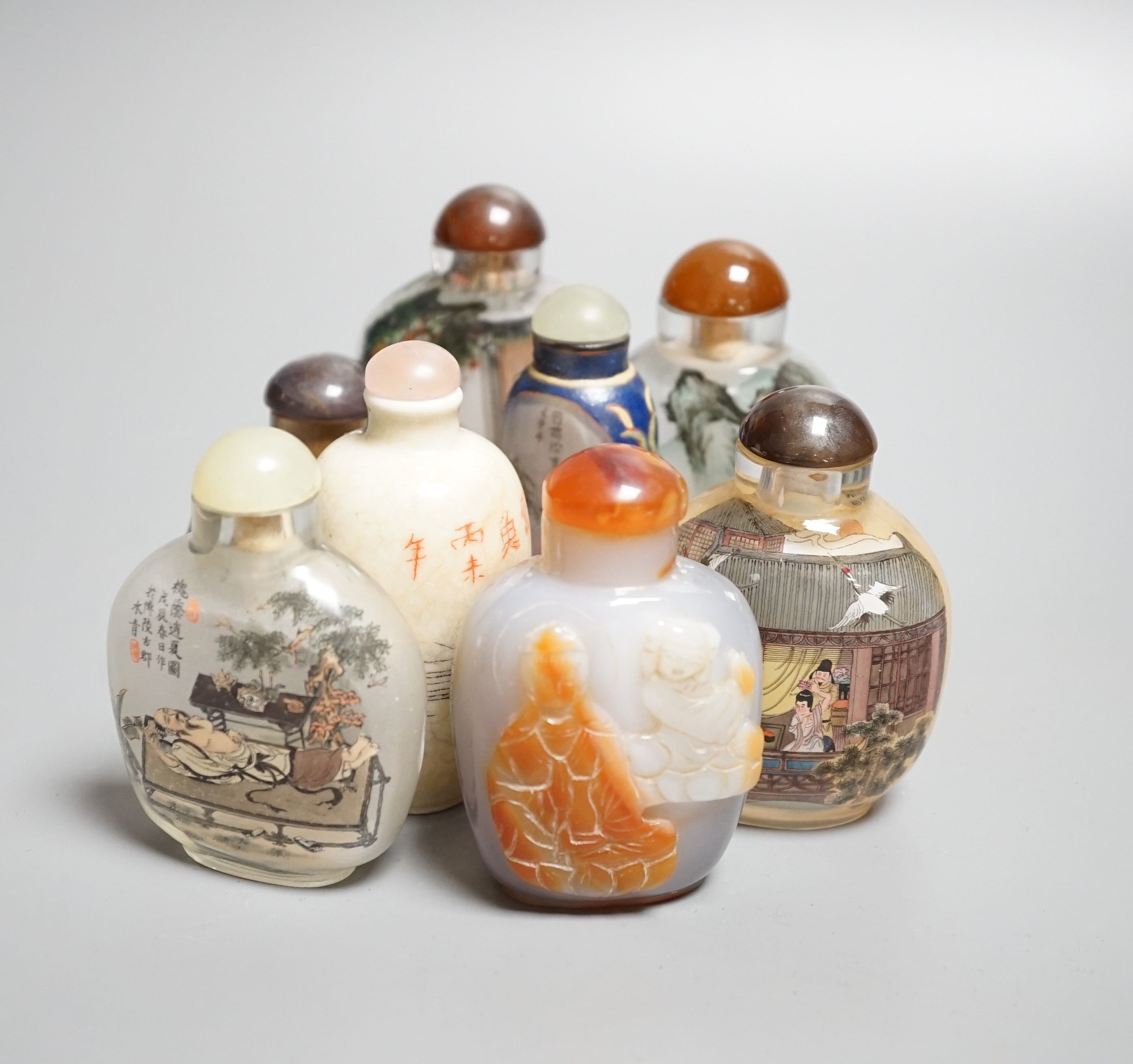 Six Chinese inside painted glass snuff bottles, an agate cameo snuff bottle and an incised crackle glaze snuff bottle, tallest 9cm